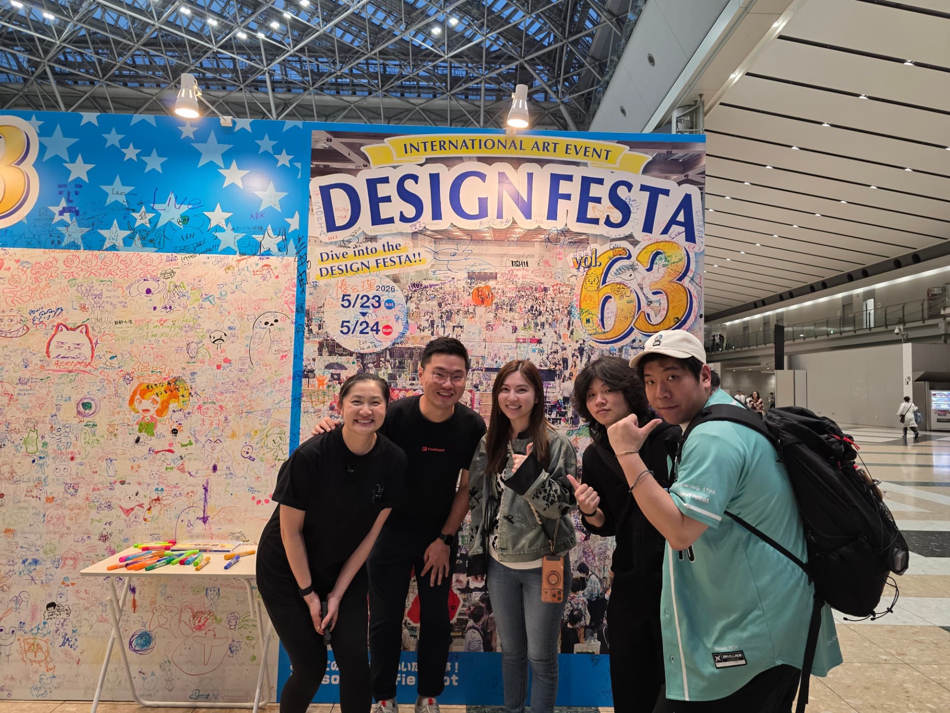 The Glowing Star team and Rabitt Planet in front of the Design Festa Vol. 63 signage